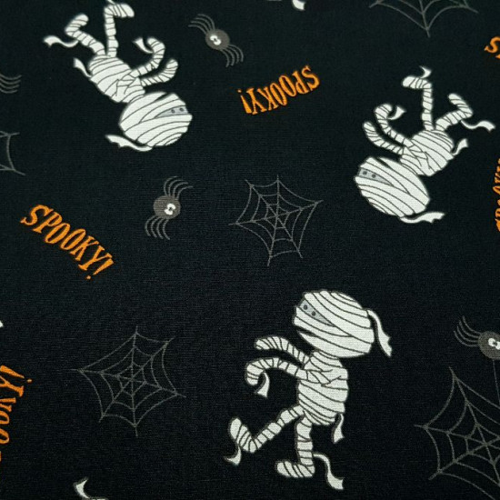 Cotton Halloween Mummies Spiders fabric Cotton Halloween Mummies Spiders fabric - Halloween-themed cotton fabric, with drawings of mummies, spiders and cobwebs on a black background. The fabric is 140cm wide and its composition 100% cotton.